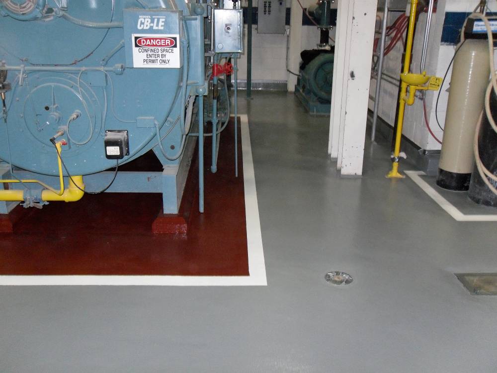 New epoxy floor coating protects the boiler room floor. Note the careful drain sloping.