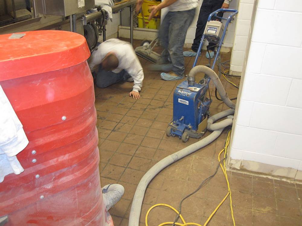 Existing tile floor was shot blast in preparation.