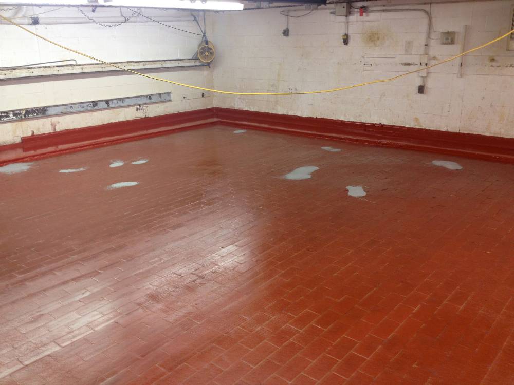 Proofer room after failed coating was removed, bricks primed and damaged areas patched.