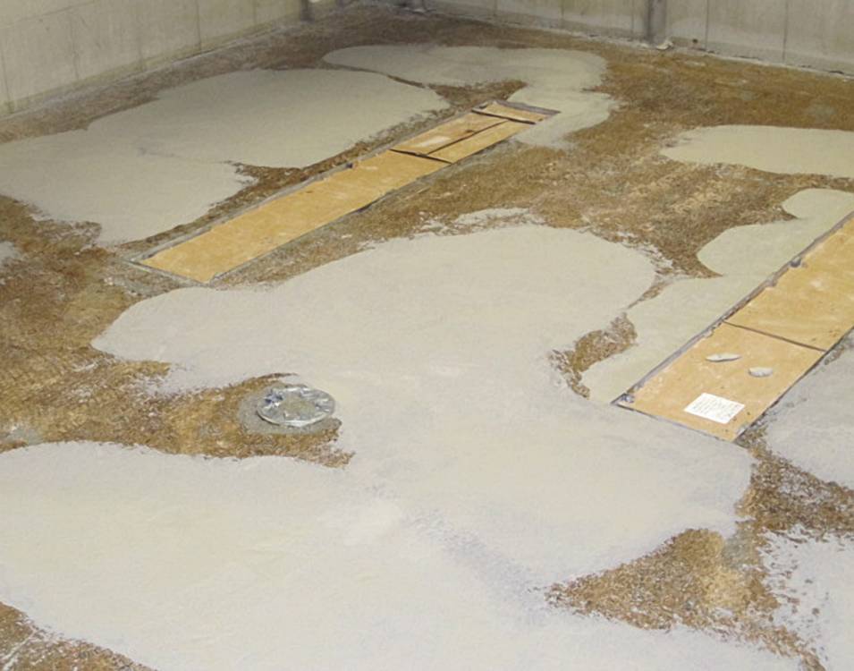 Damaged areas around drains are patched and leveled.