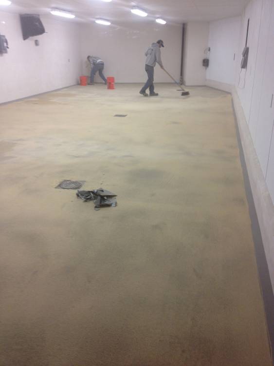 Non-slip aggregate is broadcast into the coating.