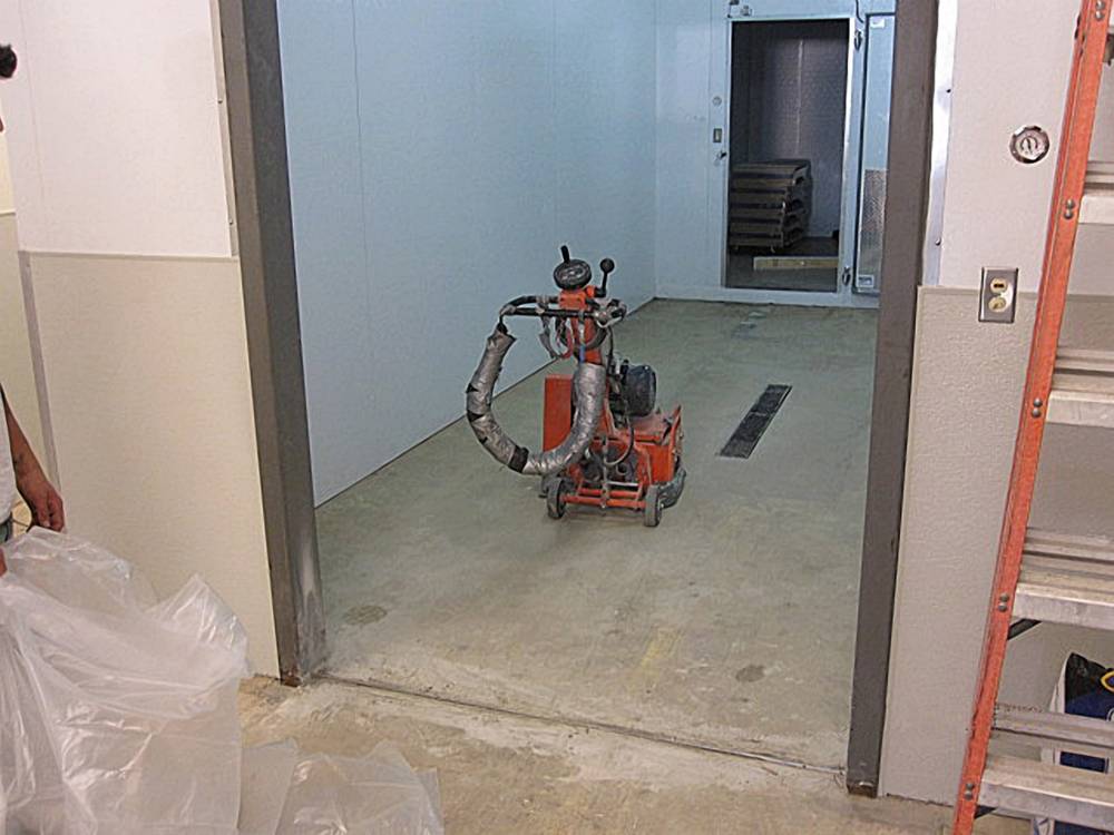 A grinder was used to level and prepare the surface.