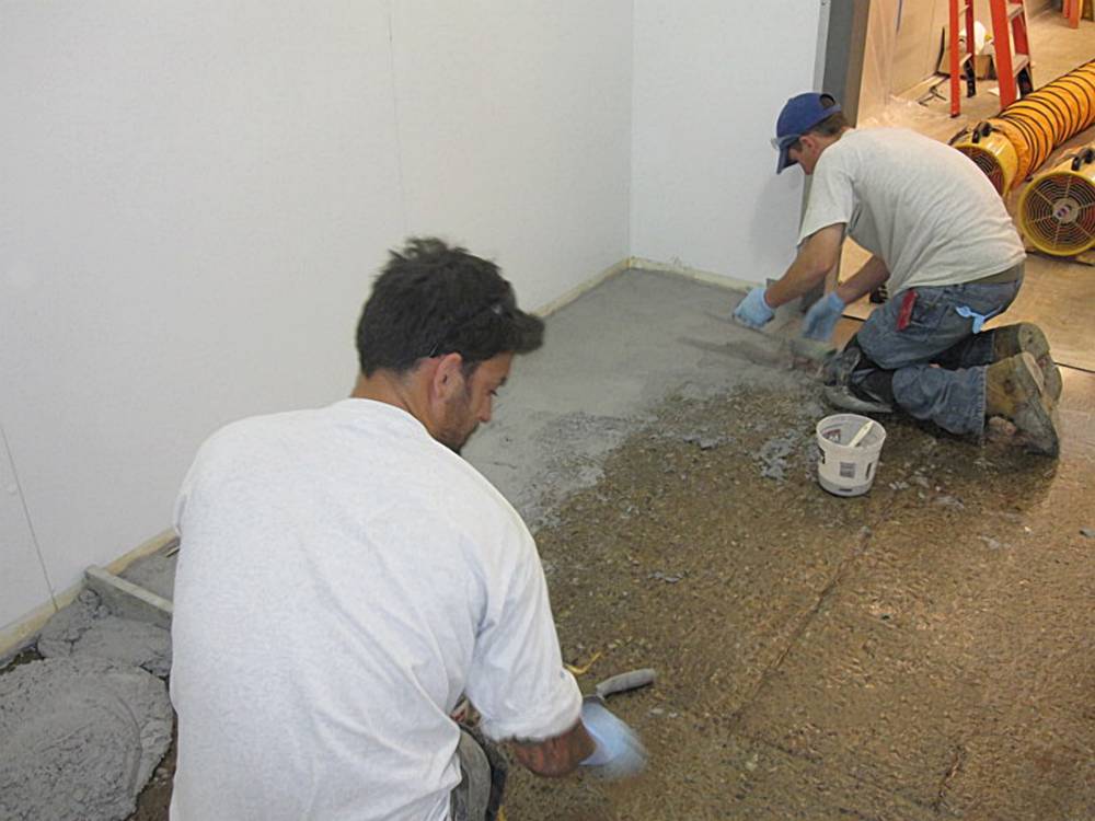 Spalling damage is patched and floor re-profiled for better drainage.