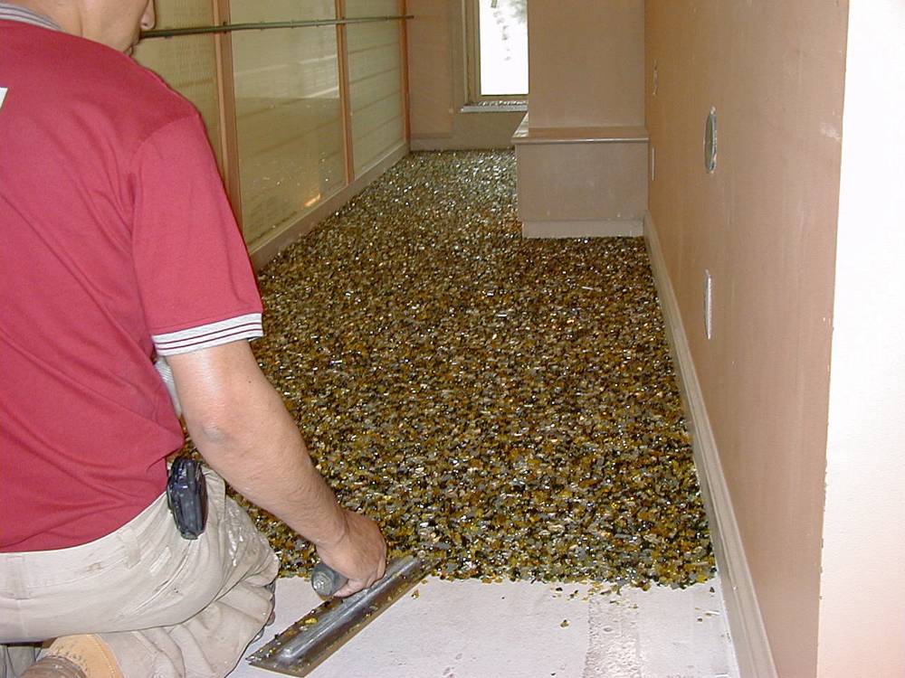 Glass material is applied by hand trowel.